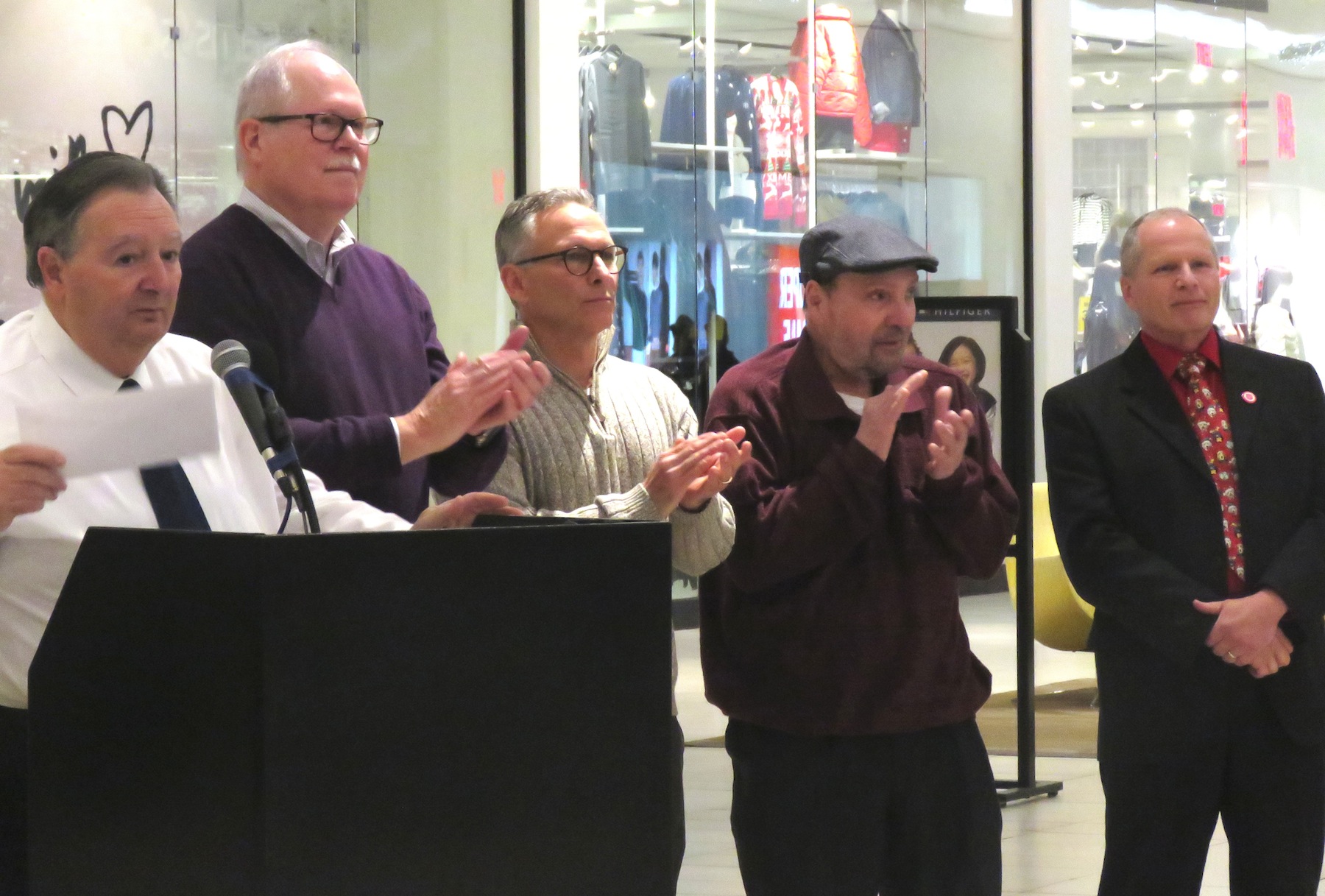 From left, Town of Niagara Supervisor Lee Wallace, Town of Niagara councilmen Marc Carpenter, Sam Gatto and Rich Sirianni, and Fashion Outlets Manager John Doran hand out checks to a long list of beneficiaries Tuesday at the town and mall's `Giving Fashionably` event. (Photo by David Yarger)